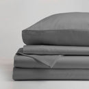 The Morgan and Reid Hotel 1500 Thread Count Cotton Rich Sheet Set, with pillowcases and one pillow on top, is neatly stacked and displayed against a plain light gray background.