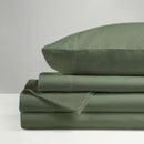 The Morgan and Reid Hotel 1500 Thread Count Cotton Rich Sheet Set, with pillowcases and one pillow on top, is neatly stacked and displayed against a plain light gray background.