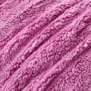 A vibrant crocus pink Snuggle Fleece Comforter set with layered pillows, adding warmth and colour to a modern bedroom.