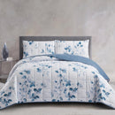 Lightweight quilted coverlet with matching pillowcases in soft blue floral design.
