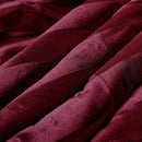 The Morgan and Reid Cherry Red Velvet Stripe Snuggle Fleece European Pillowcase Pair features alternating shiny and matte burgundy stripes, perfect for layering with square throw pillows or adding style to your bed.