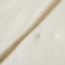 Lightweight coconut cooling comforter layered on rattan bed frame.