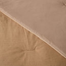 Close-up of a textured brown fabric with a ribbed pattern