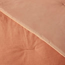 Close-up of a textured pink fabric with a ribbed pattern