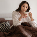 Woman holding a mug in a cozy indoor setting