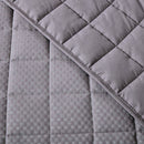 Close-up of a quilted gray fabric with diamond pattern