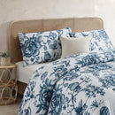 Lightweight quilted coverlet with pillowcases in classic blue rose design.