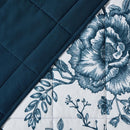 Lightweight quilted coverlet with pillowcases in classic blue rose design.