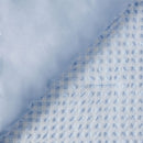 Close-up of blue and white checkered fabric with a textured pattern.