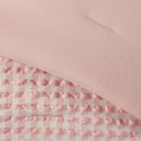 Pink checkered fabric on a pink background