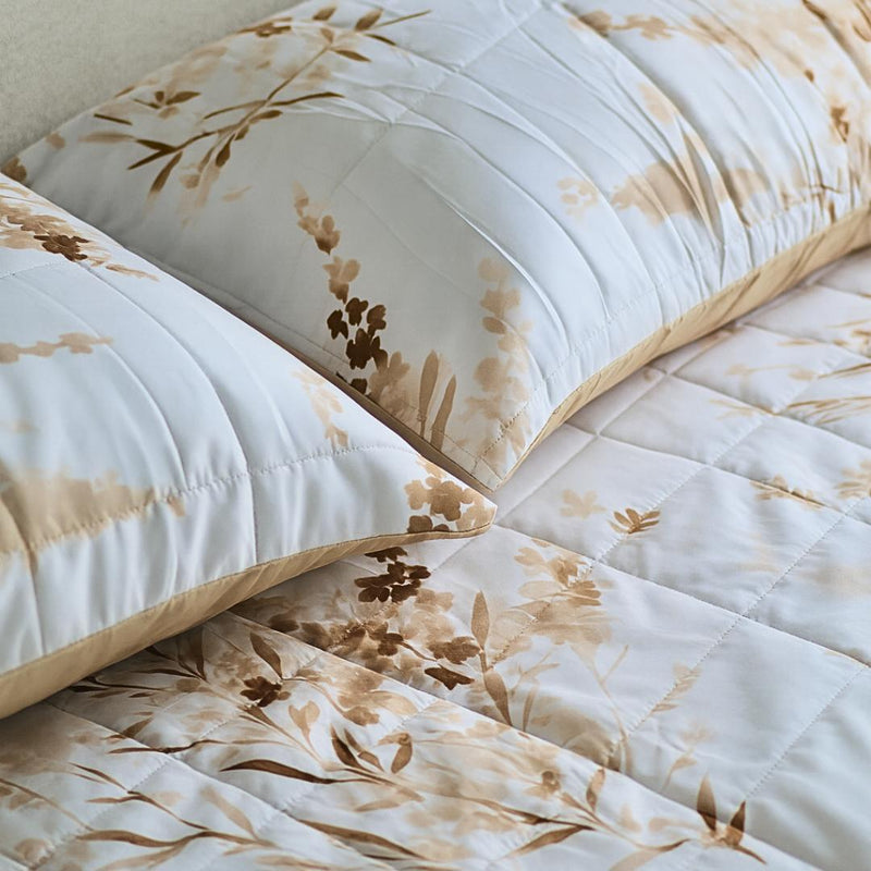 Close-up of golden floral quilted design and stitching.