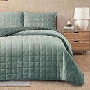 green quilt on bed