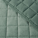 close up of quilting fabric of green quilt