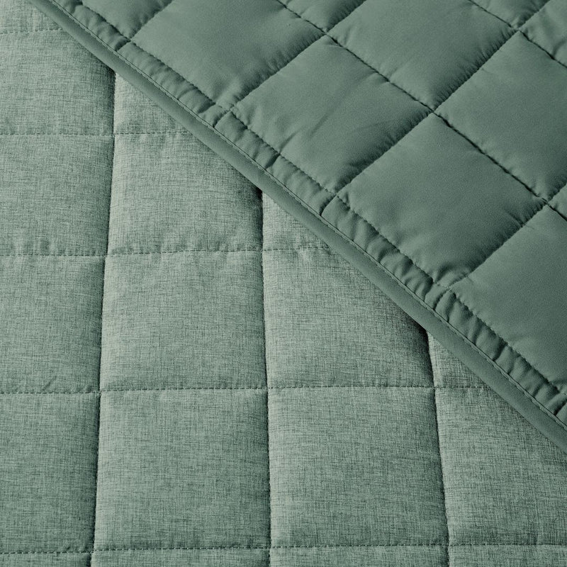 close up of quilting fabric of green quilt