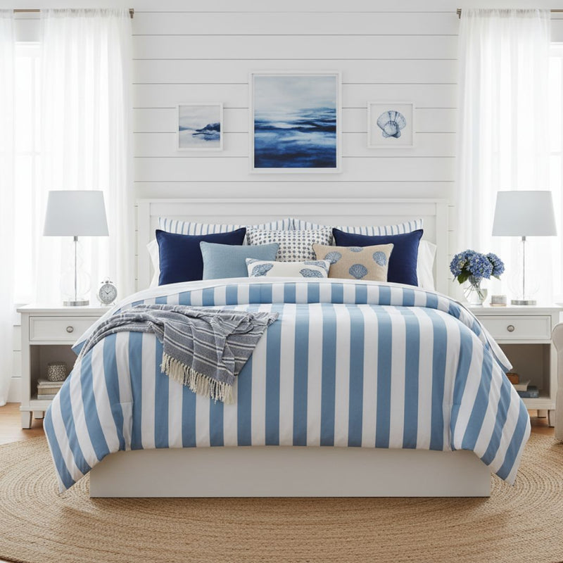 Bedroom with blue and white striped bedding, pillows, and decor.