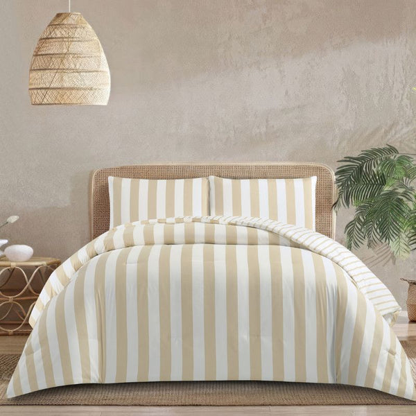 A coastal-inspired bedroom shows the Morgan and Reid Driftwood Stripe Comforter Set on a neatly made bed with striped pillowcases, rattan headboard, soft neutral walls, woven pendant light, and a round wooden side table.