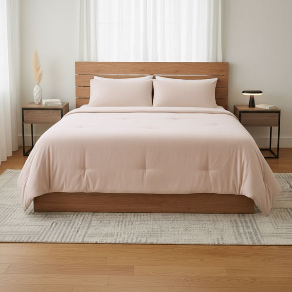 Bedroom with a wooden bed frame, pink bedding, and nightstands.