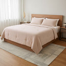Beige comforter on a wooden bed in a bedroom setting