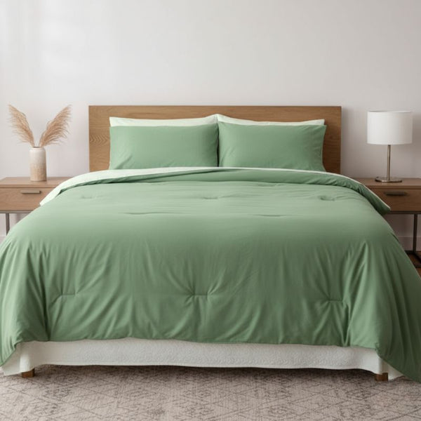 Green bedspread on a bed with wooden headboard and nightstands in a bedroom setting.