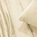 A modern bedroom with a beige upholstered bed and cream bedding exudes winter comfort, enhanced by the Morgan and Reid Winter Microplush Sheet Sets ultra-soft fabric, neutral decor, dried flowers, and light wood floors.