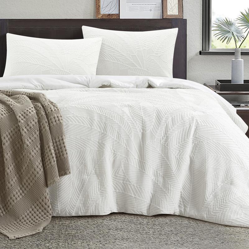 Soft textured white quilt cover creating a relaxed coastal-inspired bedroom look.