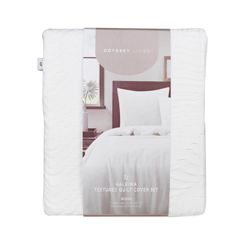 Soft textured white quilt cover creating a relaxed coastal-inspired bedroom look.