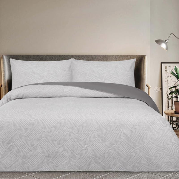 Modern bedroom featuring Odyssey Living Soho Silver Comforter with neutral decor.