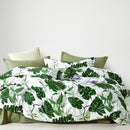 Odyssey Living Tahiti Cotton Quilt Cover Set styled on a bed with tropical leaf print.