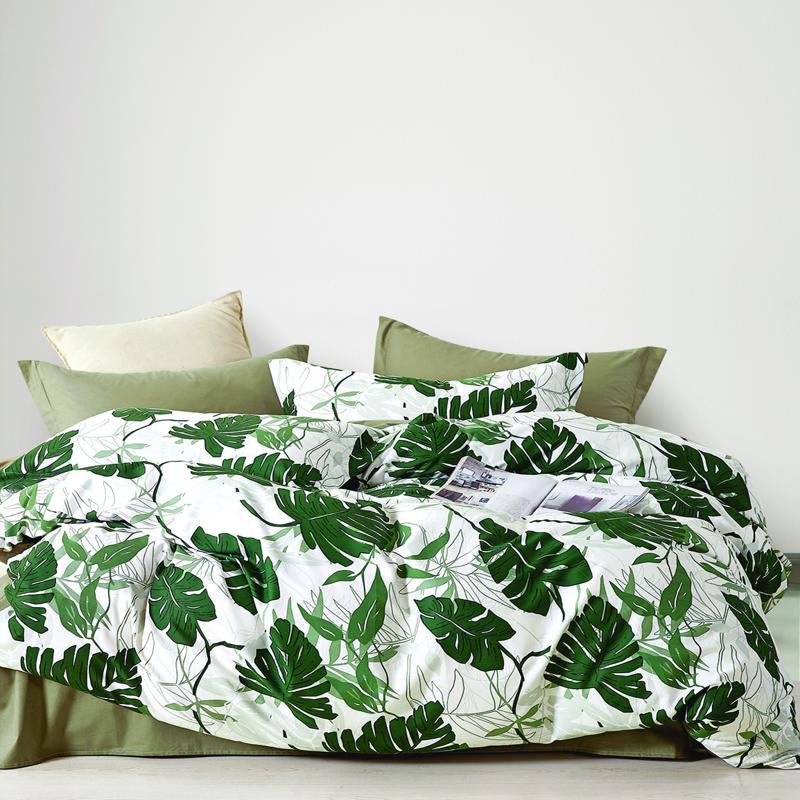 Odyssey Living Tahiti Cotton Quilt Cover Set styled on a bed with tropical leaf print.