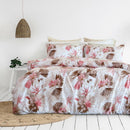 Tropical floral Odyssey Living comforter adding relaxed coastal charm to a white bedroom.