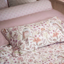 PIP Studio Garden of Dove Off-White Cushion with floral and dove design styled on bed.