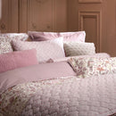 PIP Studio Garden of Dove Off-White Cushion with floral and dove design styled on bed.