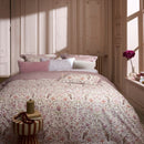 PIP Studio Garden of Dove Off-White Quilt Cover Set styled on a bed with soft floral detailing.