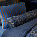 Close-up of Tutti i Fiori roll cushion showing detailed flowers and tie finish.