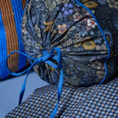 Close-up of Tutti i Fiori roll cushion showing detailed flowers and tie finish.