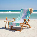 Renee Taylor Jacquard Velour Blue Cabana Beach Towel with blue, lilac, and pink stripes.
