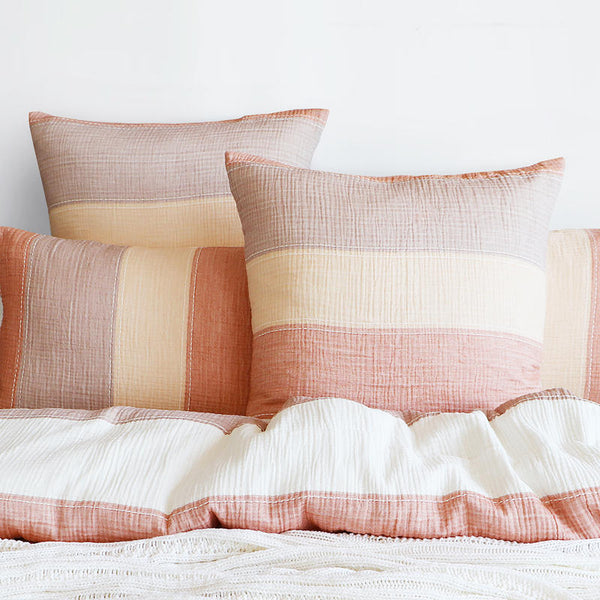 Styled bed featuring Renee Taylor Bayley European Pillowcases in soft earthy tones.