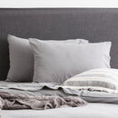 Charcoal organic cotton jersey pillowcase set styled on a soft, modern bed.