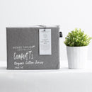 Charcoal organic cotton jersey pillowcase set styled on a soft, modern bed.