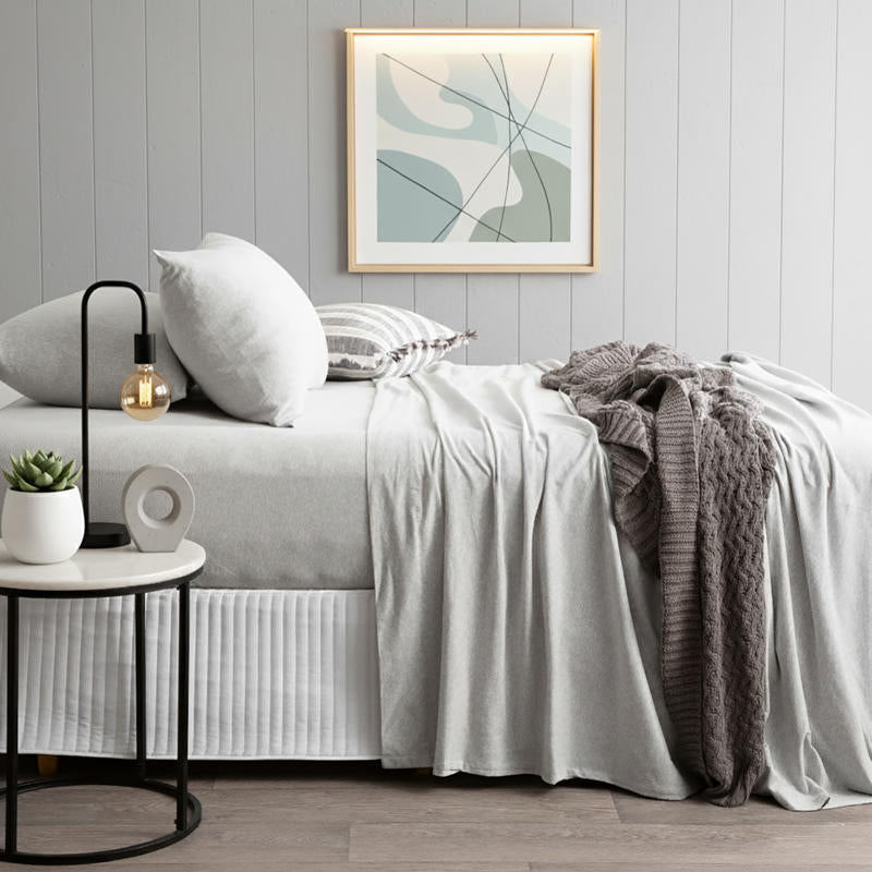 Pillowcase set in light grey marle paired with matching sheet set and neutral throw.