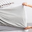 Pillowcase set in light grey marle paired with matching sheet set and neutral throw.