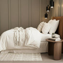 Cosy bedroom scene featuring the Renee Taylor Oatmeal Quilt Cover Set with matching pillowcases.