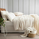 Oatmeal organic cotton jersey pillowcase set styled on a soft, neutral bed.