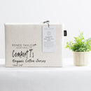Oatmeal organic cotton jersey pillowcase set styled on a soft, neutral bed.