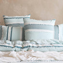 Styled bed featuring Renee Taylor Montego European Pillowcases with a soft coastal look.