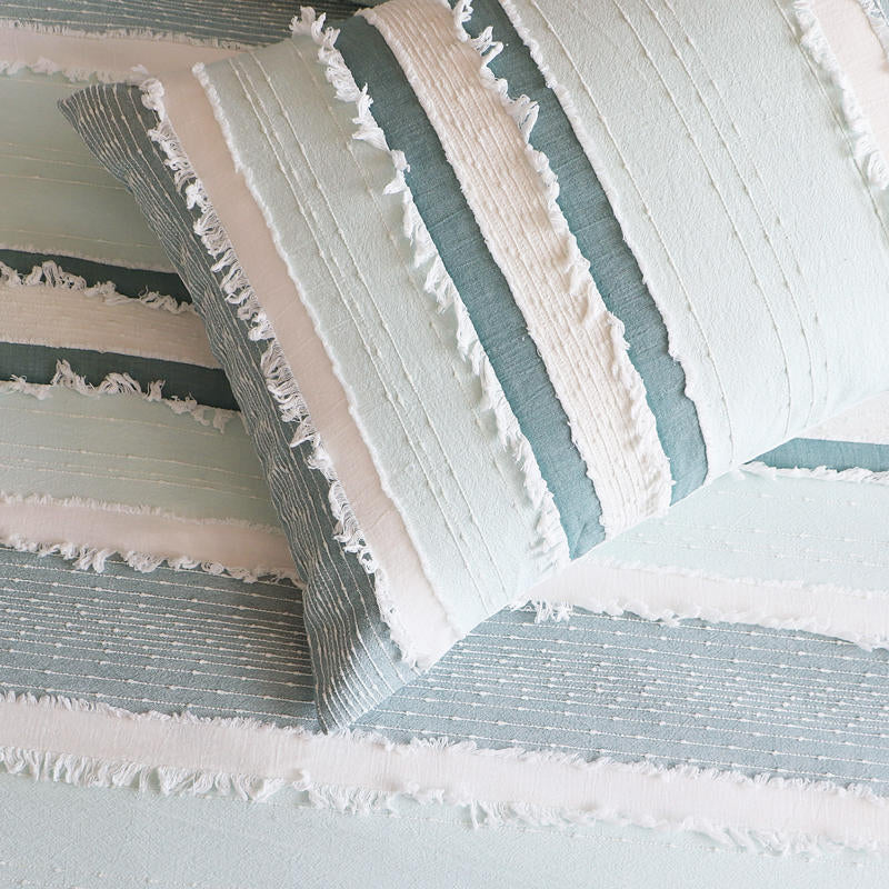 Styled bed featuring Renee Taylor Montego European Pillowcases with a soft coastal look.