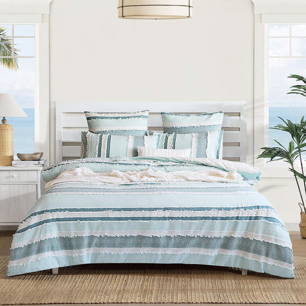 Renee Taylor Montego Quilt Cover Set styled in a coastal bedroom with ocean views.