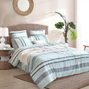 Renee Taylor Montego Quilt Cover Set styled in a coastal bedroom with ocean views.