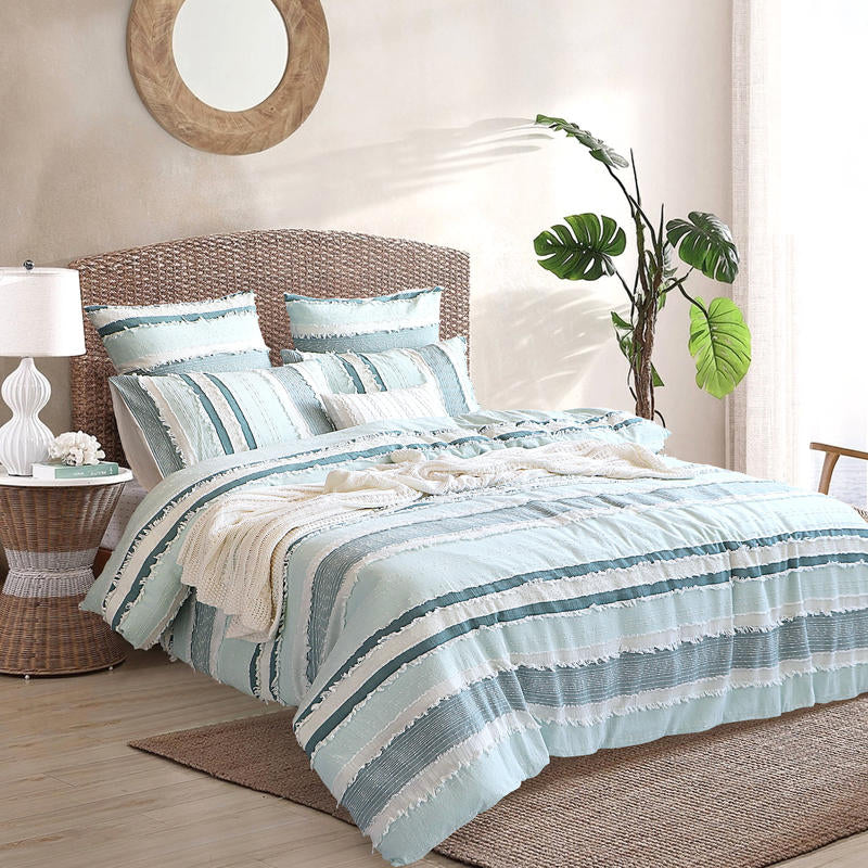 Renee Taylor Montego Quilt Cover Set styled in a coastal bedroom with ocean views.