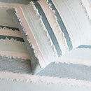 Renee Taylor Montego Quilt Cover Set styled in a coastal bedroom with ocean views.